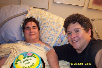 Margaret and Cynthia on our 20th anniversary, Sept. 25, 2004, with cake my father brought us. Margaret had been diagnosed as dying a couple of weeks earlier and received hospice care in our home, which was her wish.