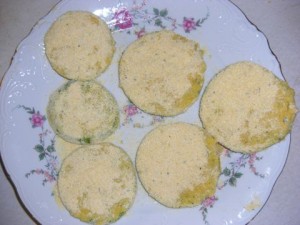 Green tomatoes coated with corn meal mixture and ready to fry.