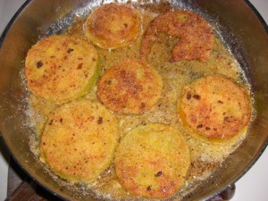 Green tomatoes frying on flip side.