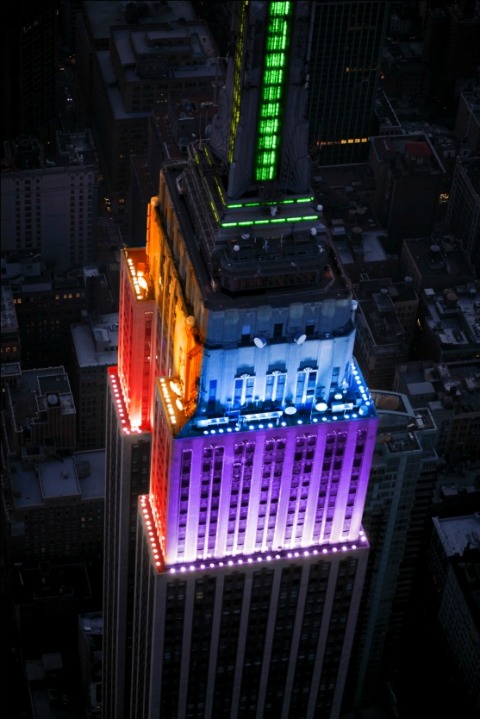 Empire State Building bathed in a rainbow of lights.
