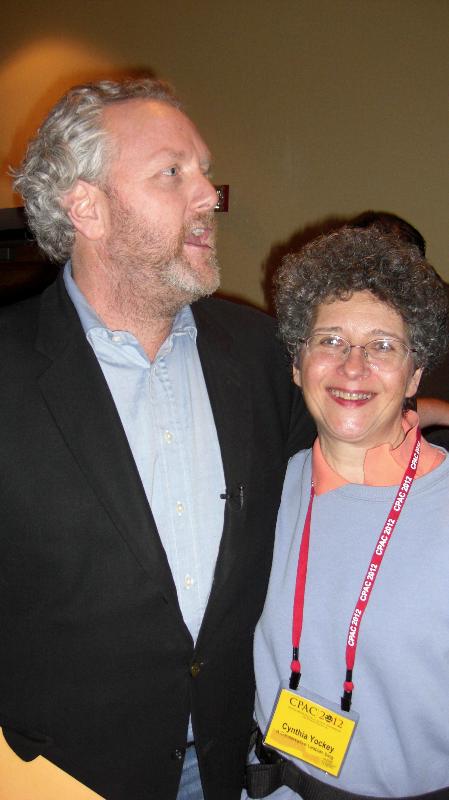 Andrew Breitbart and Cynthia Yockey in the Bloggers Lounge at CPAC 2012. Andrew is arguing with Leftist gadfly, Liz Glover, who was trying to portray Andrew as homophobic without realizing he had his arm around A Conservative Lesbian. I'd asked Andrew to pose with me with the intention of using the photo for my crosspost of an op-ed piece I wrote for The Advocate explaining why Andrew Breitbart was a better friend to gays than Barack Obama because the gay community needs fiscal conservatism to thrive.