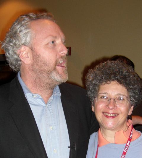 Andrew Breitbart is shown arguing with Leftist media gadfly, Liz Glover, who is accusing him of homophobia while he has his arm around blogger Cynthia Yockey, A Conservative Lesbian.