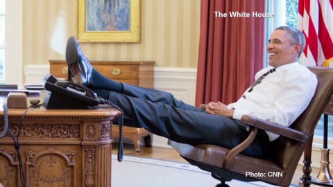 Obama with feet on desk in Oval Office