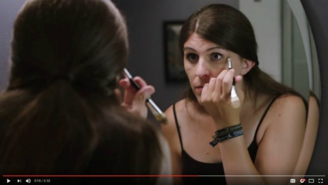 Danica Roem applying make-up while looking in the mirror, from his 2017 campaign YouTube ad